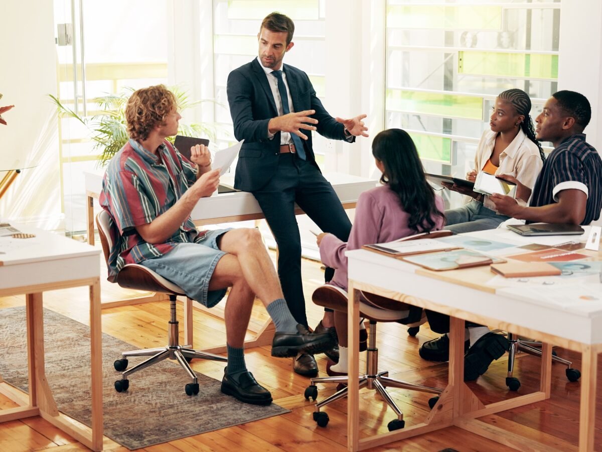 Small team having a focused conversation in a creative workspace