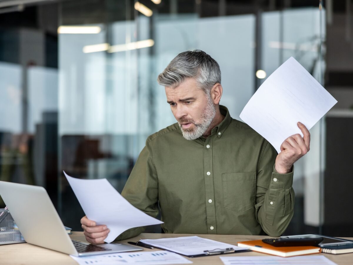 Business owner reviewing financial planning documents at a desk